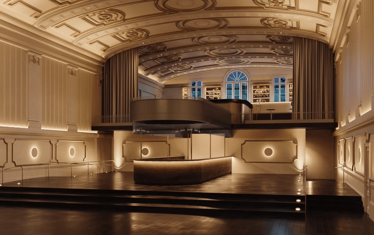 A large ballroom with high ceilings and a centre bar. 