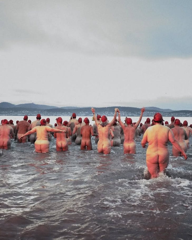 People running naked into water.