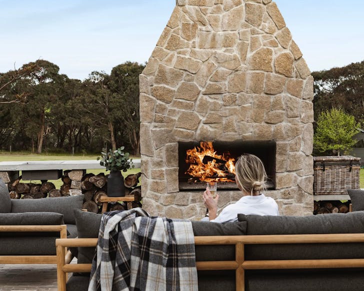The outdoor lounge and fireplace at Image credit: Oakstone Estate Guesthouse Airbnb Mornington
