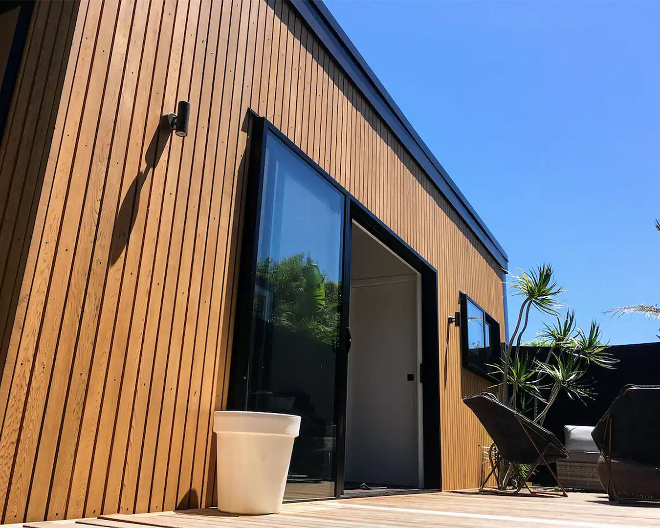 The wooden exterior of the Oasis in the bridge, one of the best airbnbs in Auckland.