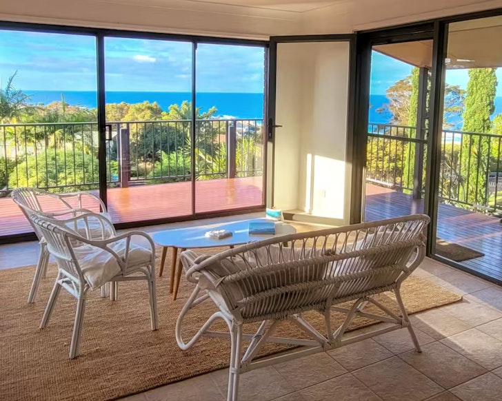 A view out to the sea from the sunroom at Ocean View Home Airbnb one of the best accommodation options in Narooma, NSW