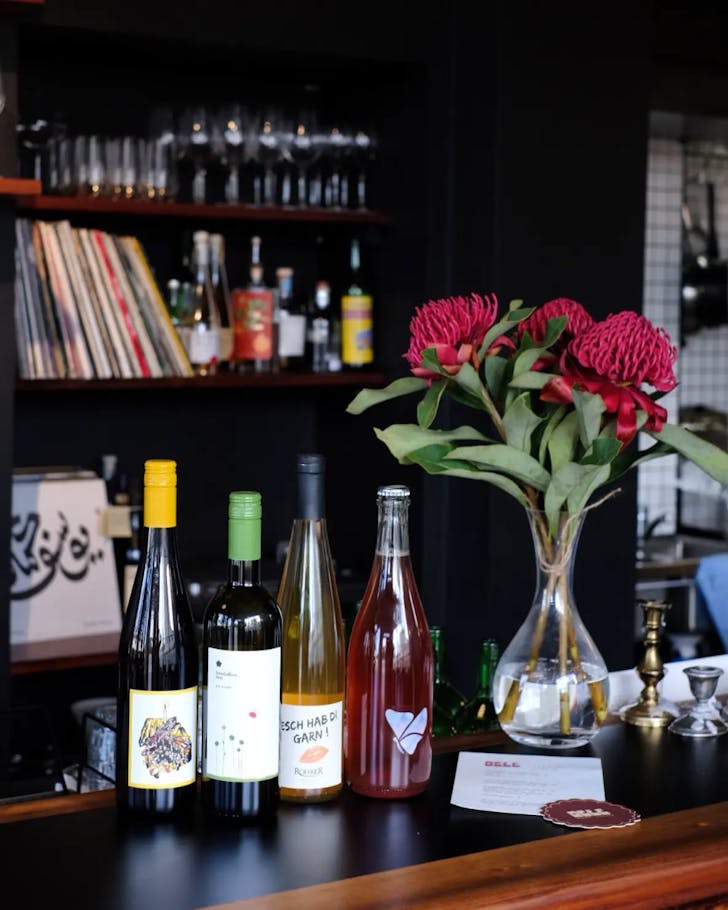 Bottles of wine on countertop in bar.