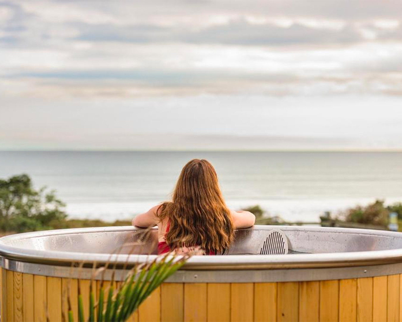 Someone relaxes in a hot tub at Ohope Beach Top 10 Holiday Park