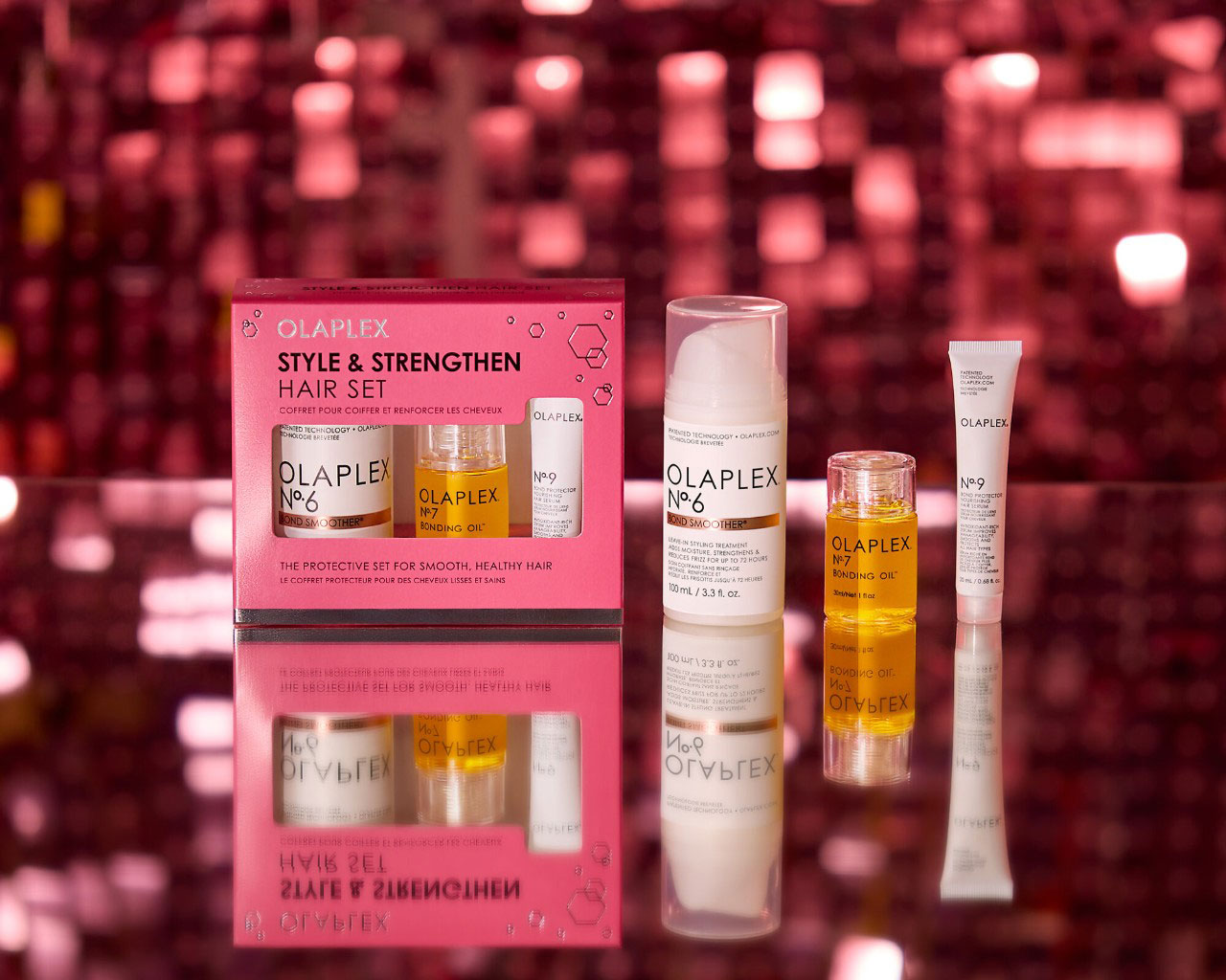 A pink box containing 3 Olaplex products with a glimmering red background.