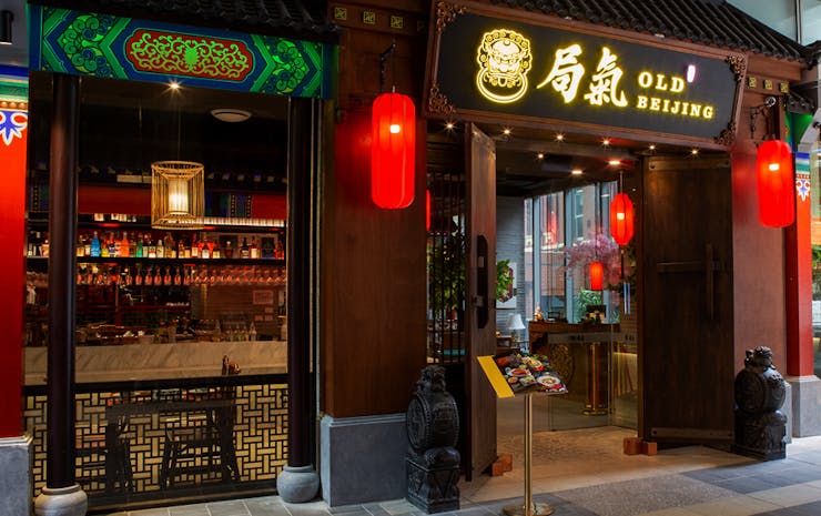 The exterior of a restaurant with red lanterns. 