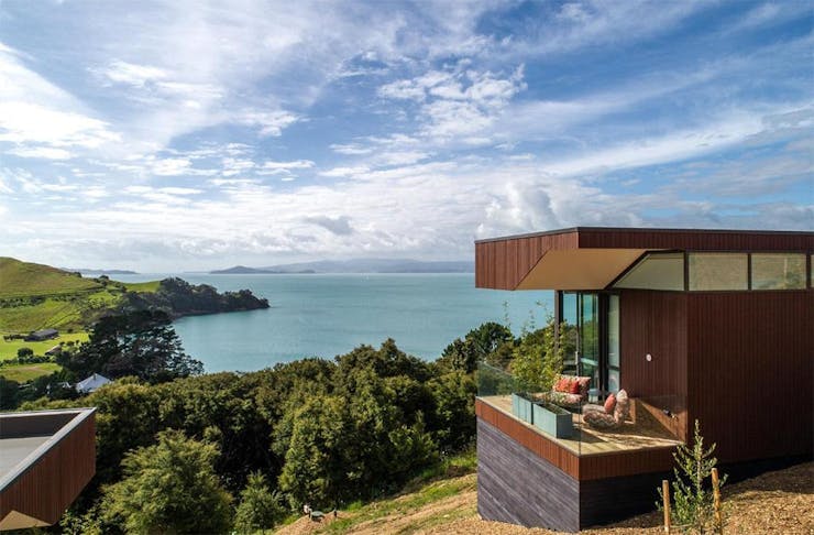 Omaha Luxury Villa, one of the most romantic getaways in Auckland, overlooks Rocky Bay on Waiheke Island. 