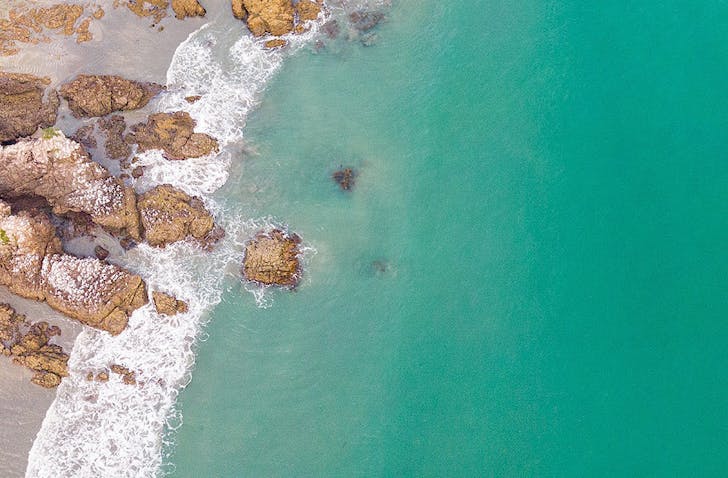 Striking blue waters and a perfect beach, reminiscent of a tropical island. 