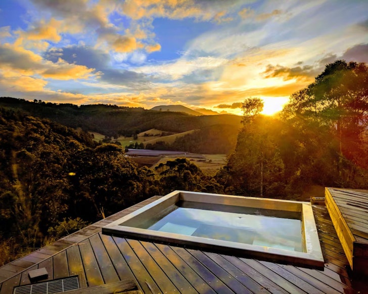 A view of the hot tub overlooking the countryside at Orchards Nest Airbnb Tasmania