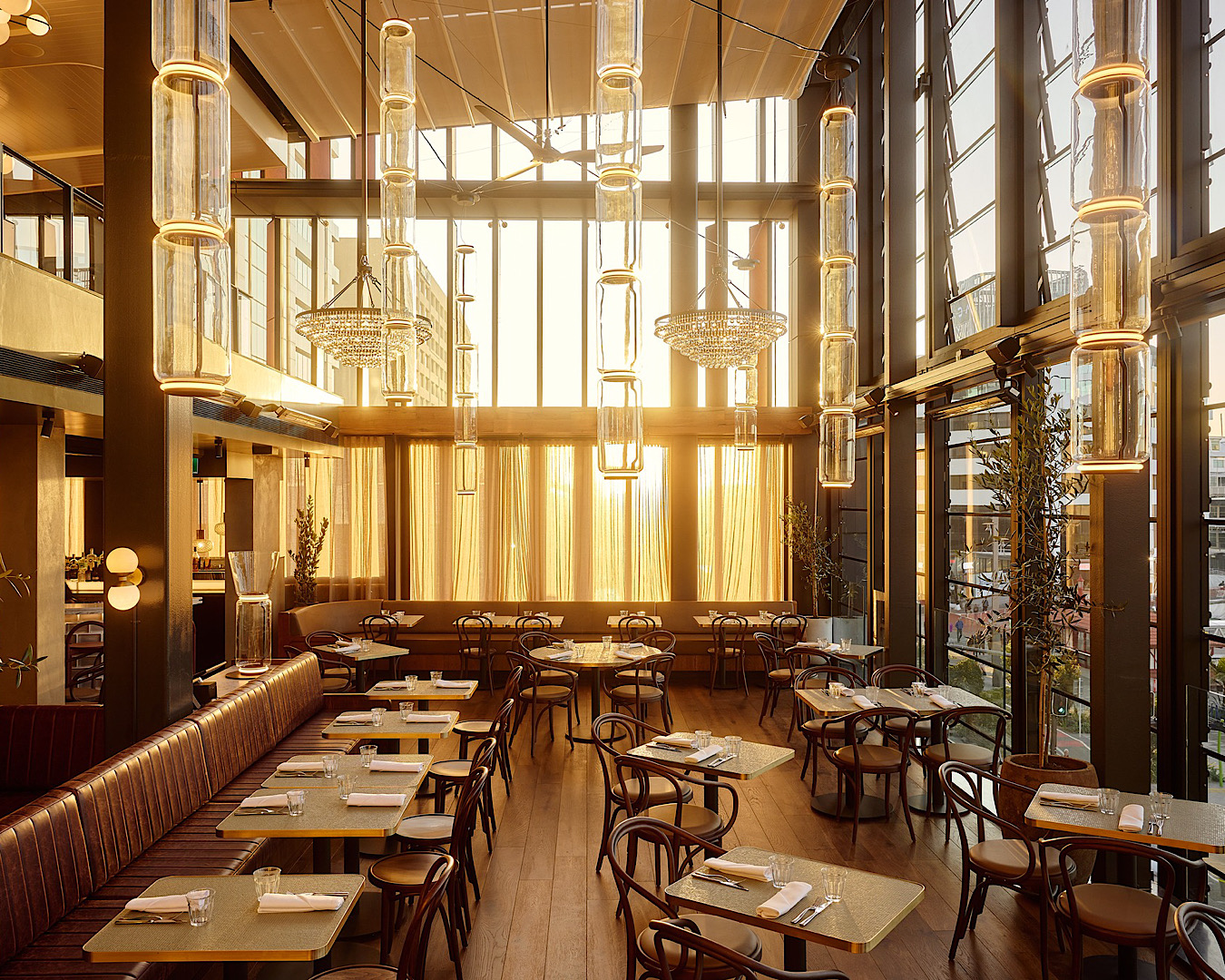 Sunlight shines through spectacular stacked glass windows at modern French bistro, Origine. 
