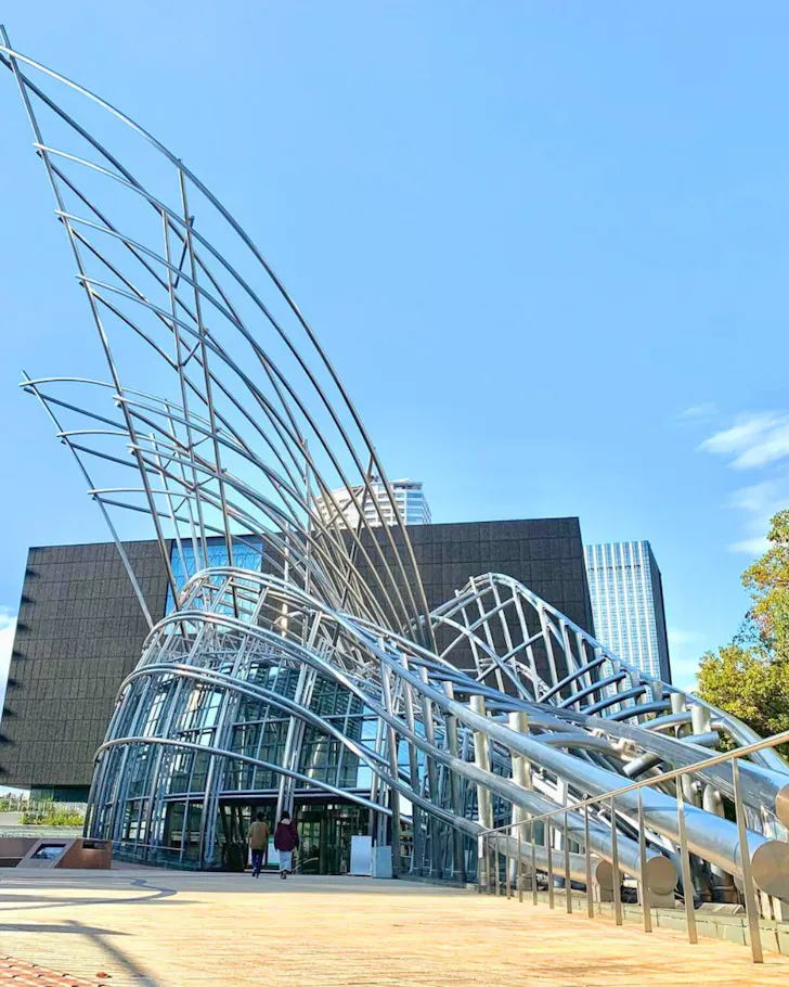 The steel facade of the National Museum Of Art on a blue-sky day in Osaka. 