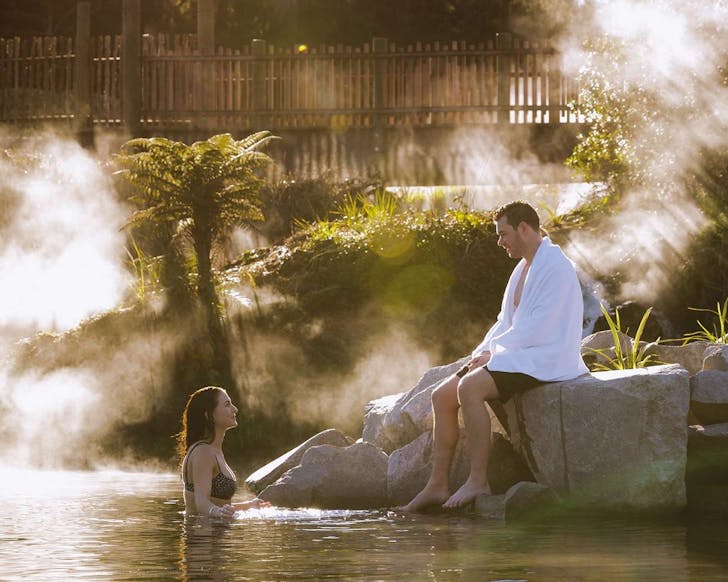 A couple enjoys the warm waters at Otumuheke Stream.
