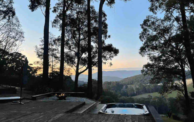 A large spa overlooking ranges at one of the best outdoor spa Airbnb Victoria.