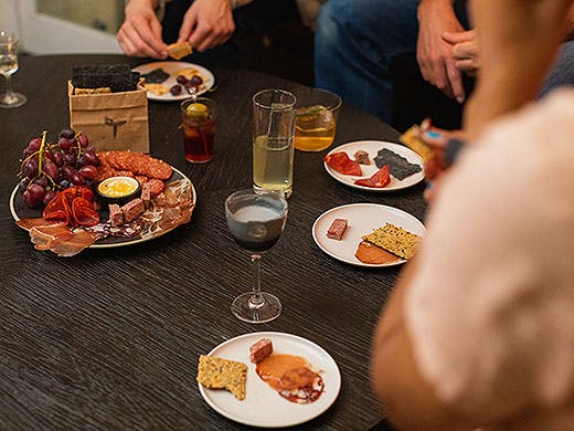 People sit around a charcuterie board at Panacea.