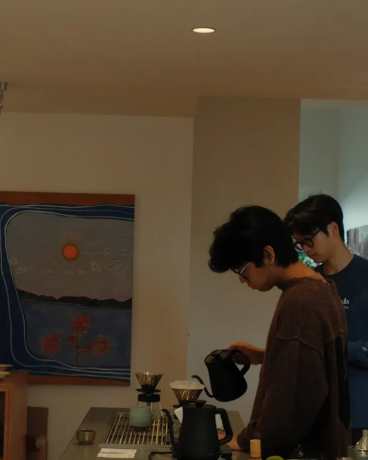A barista mindfully makes coffee.