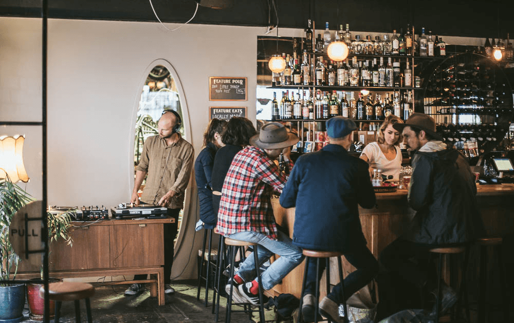 DJ playing live music and bartenders slinging local beers at one of the best bars in Melbourne, Paradise Alley.