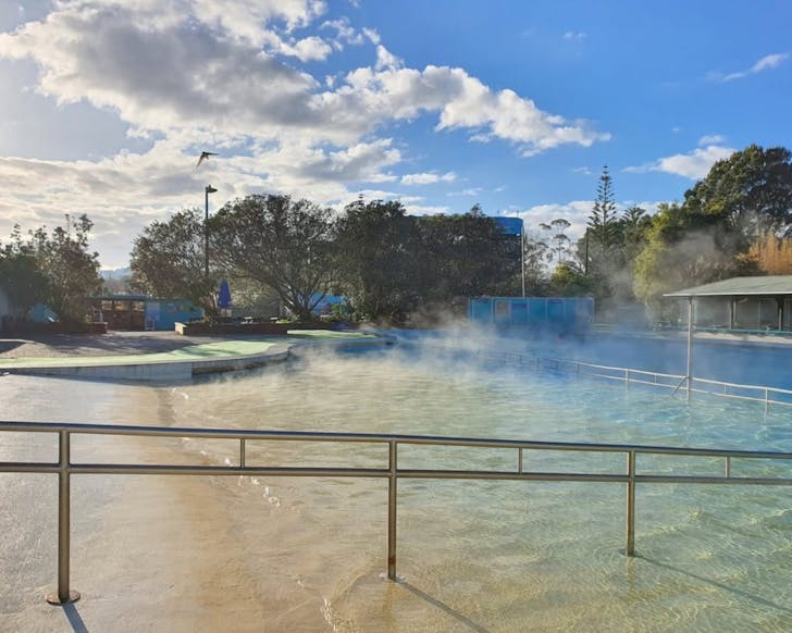 Steam rises from the huge open-air hot pool at Parakai Springs. 