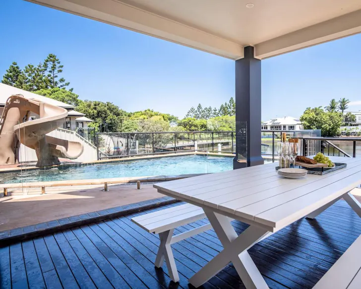 A view of the waterslide and pool at Parrearra Paradise best family friendly Airbnbs near Brisbane