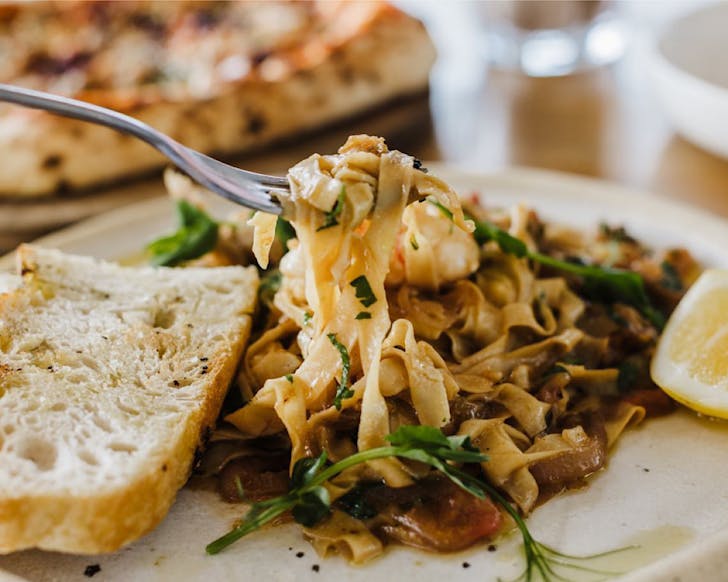 A forkful of thick pasta ribbons with herbs at Saint Alice, one of the best eateries on the Auckland Viaduct. 