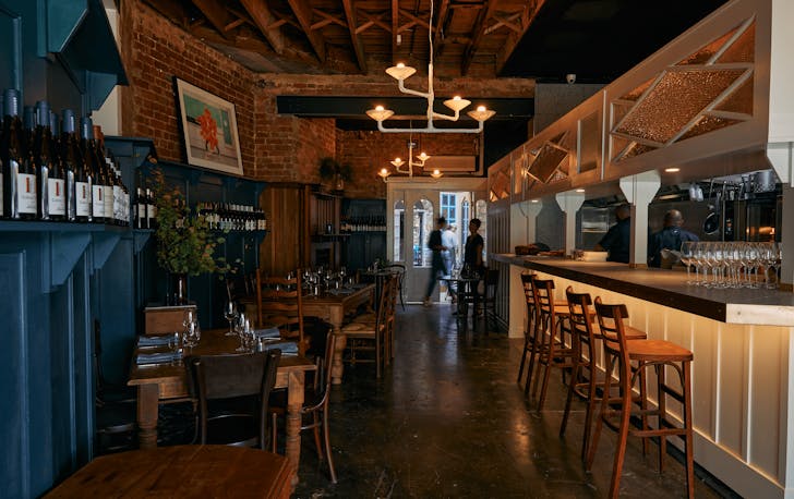 A quaint dining room with a long bar, a best contender for private dining rooms in Melbourne.