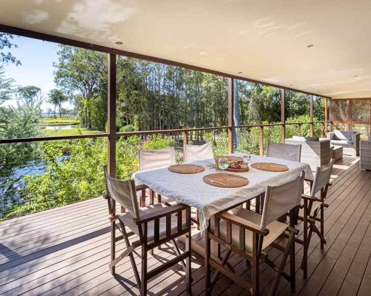 The all-weather verandah with a lake view at Pavilion Lake Weyba Cottages best Airbnbs Noosa