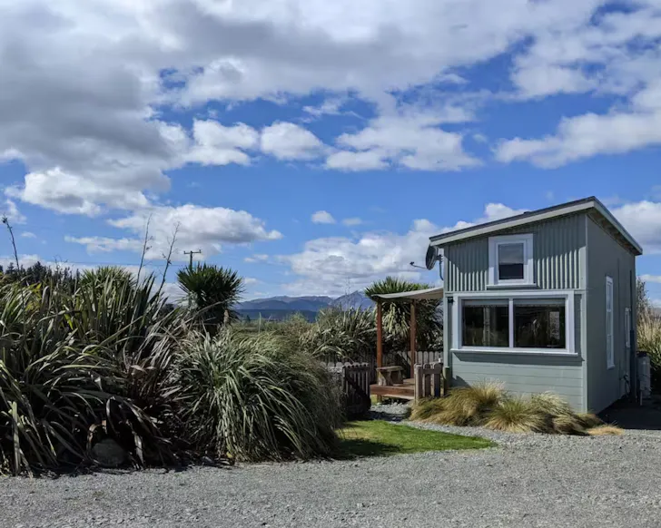 A view of the Peaceful Tiny House surrounded by landscape, one of the best accommodation options near Lake Tekapo New Zealand