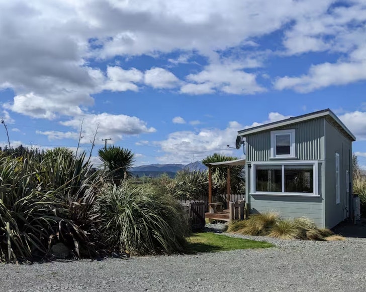 A view of the Peaceful Tiny House surrounded by landscape, one of the best accommodation options near Lake Tekapo New Zealand