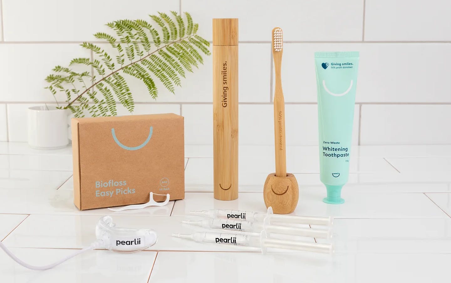 A collection of oral health products in a white bathroom. 