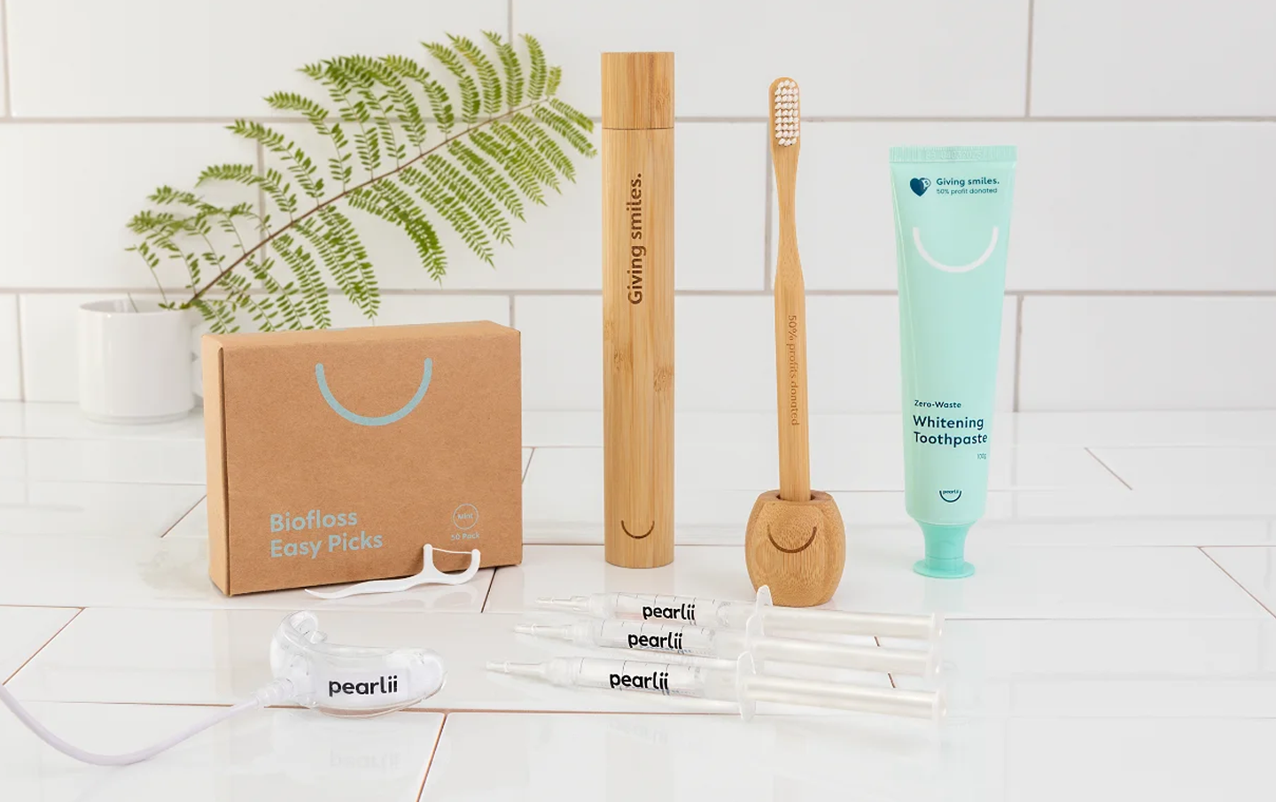A collection of oral health products in a white bathroom. 