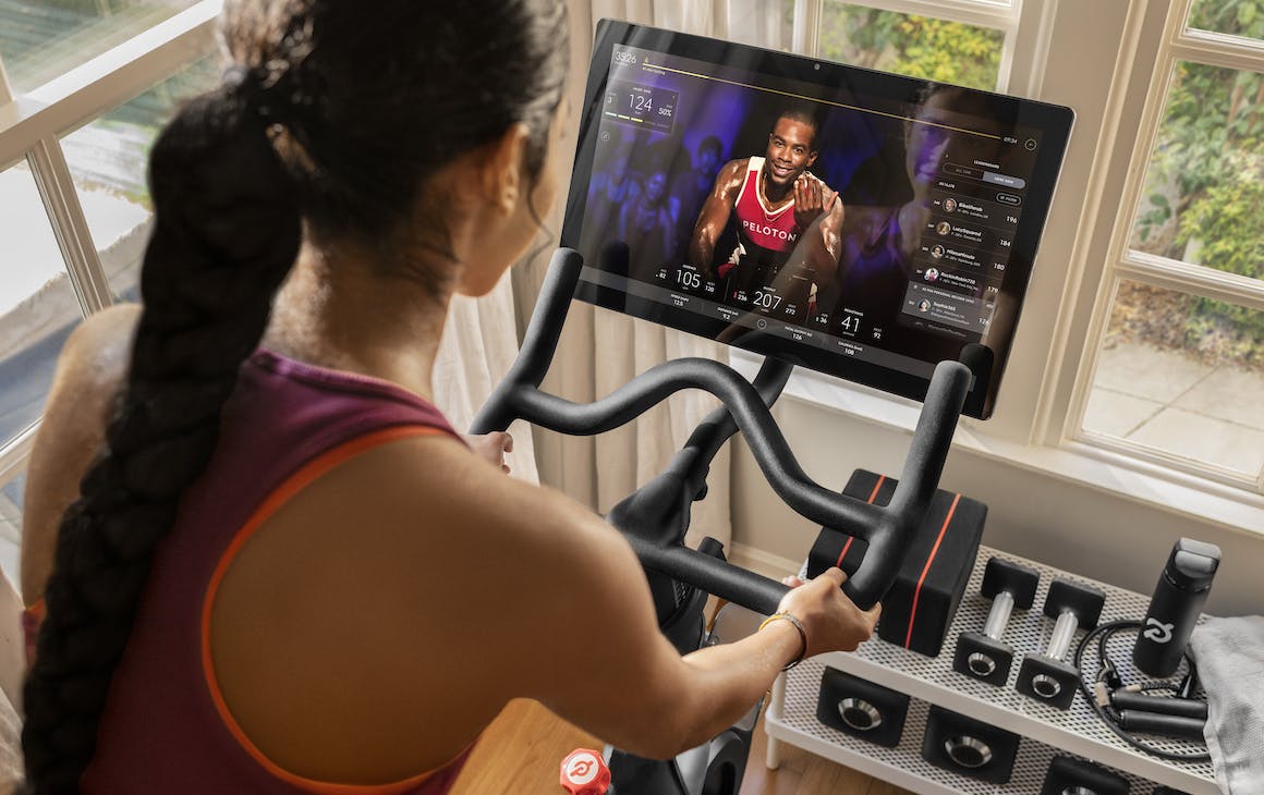 woman riding a Peloton bike