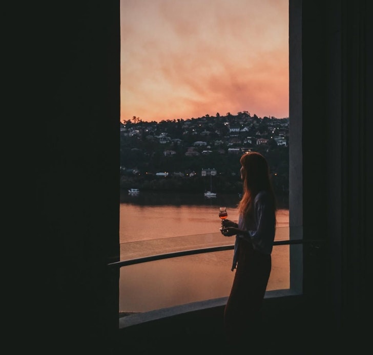 A woman looks out at the Tamar River from Peppers Silo one of the best hotels in Tasmania