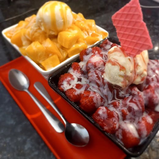 A mango and a strawberry snowflake bowl. 