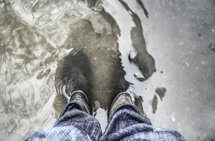 Someone standing in floodwaters. 