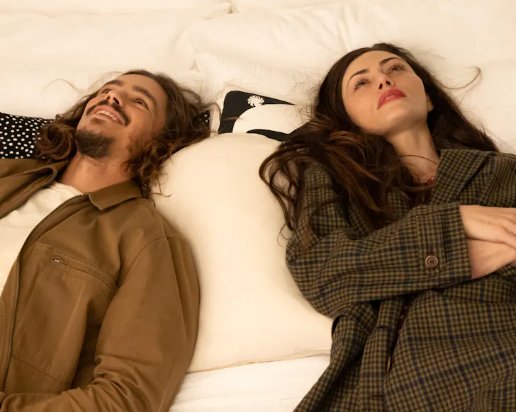 Phoebe Tonkin and Brendon Thwaites lie on a bed in the new tv series Two Years Later.