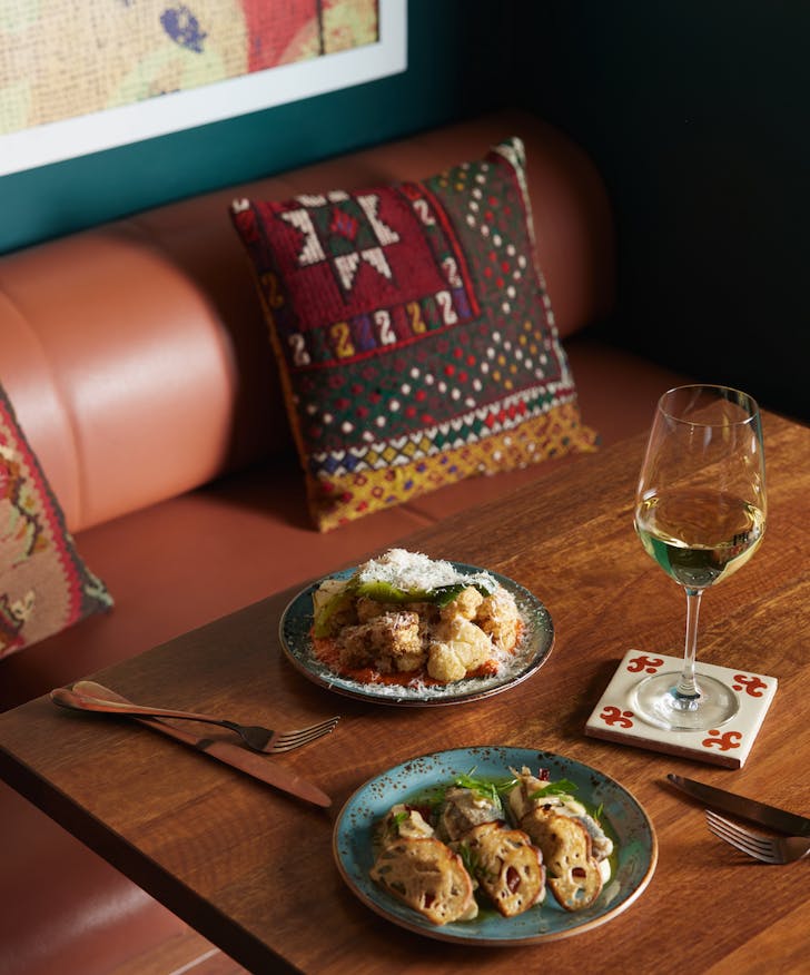 a table topped with tapas dishes and wine