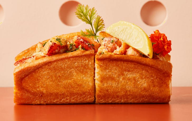A golden toasted bun filled with lobster and a lemon, one of the best lobster rolls in Melbourne. 