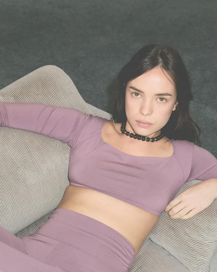 A woman wears an outfit in soft dusky mauve from Pinky & Kamal one of the best activewear brands