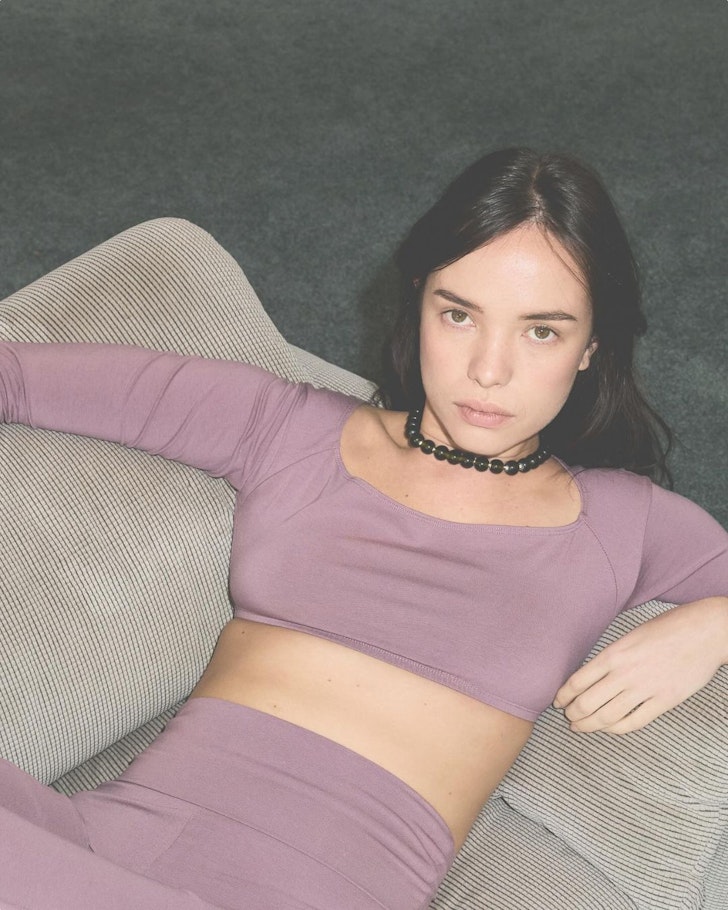 A woman wears an outfit in soft dusky mauve from Pinky & Kamal one of the best activewear brands