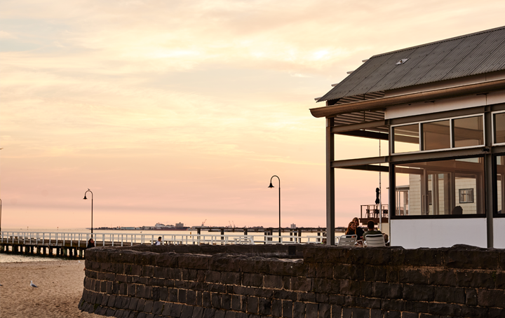 A restaurant on the beach at sunset, one of the best fish and chips Melbourne.