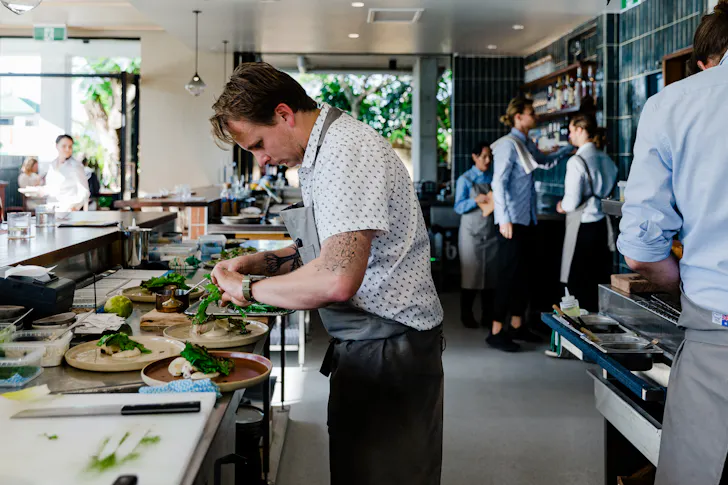 Chefs are working preparing dishes in the kitchen at Pipit.
