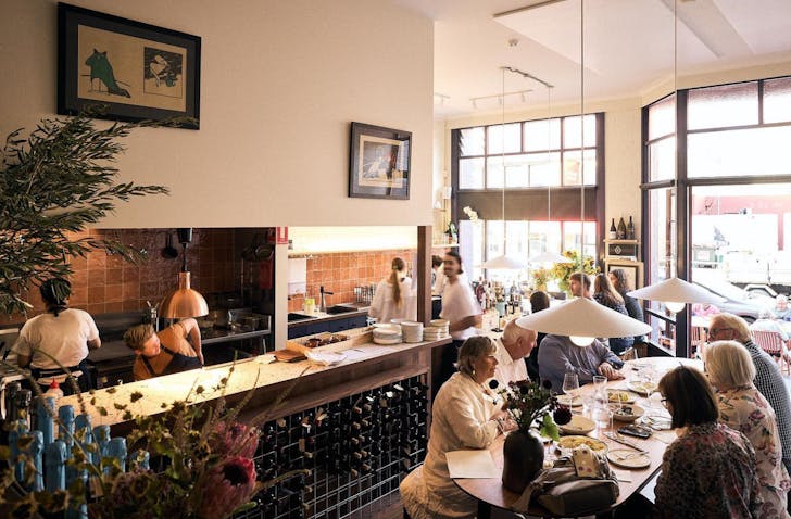 Warm, rustic interior of Pitz Pasta Bar with diners