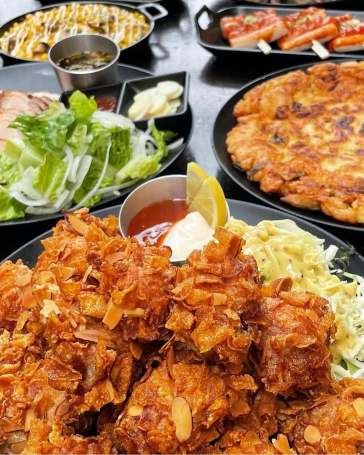 Almond Krunch Korean fried chicken covered in cornflakes and almonds.