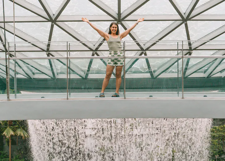 Polly Markus in front of the HSBC Rain Vortex at Jewel Changi Airport