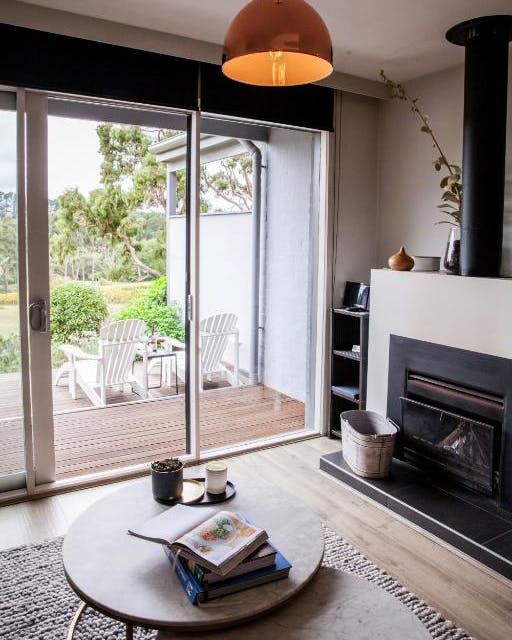A clean looking lounge room with a large pendant light, a top winery accommodation in Victoria.