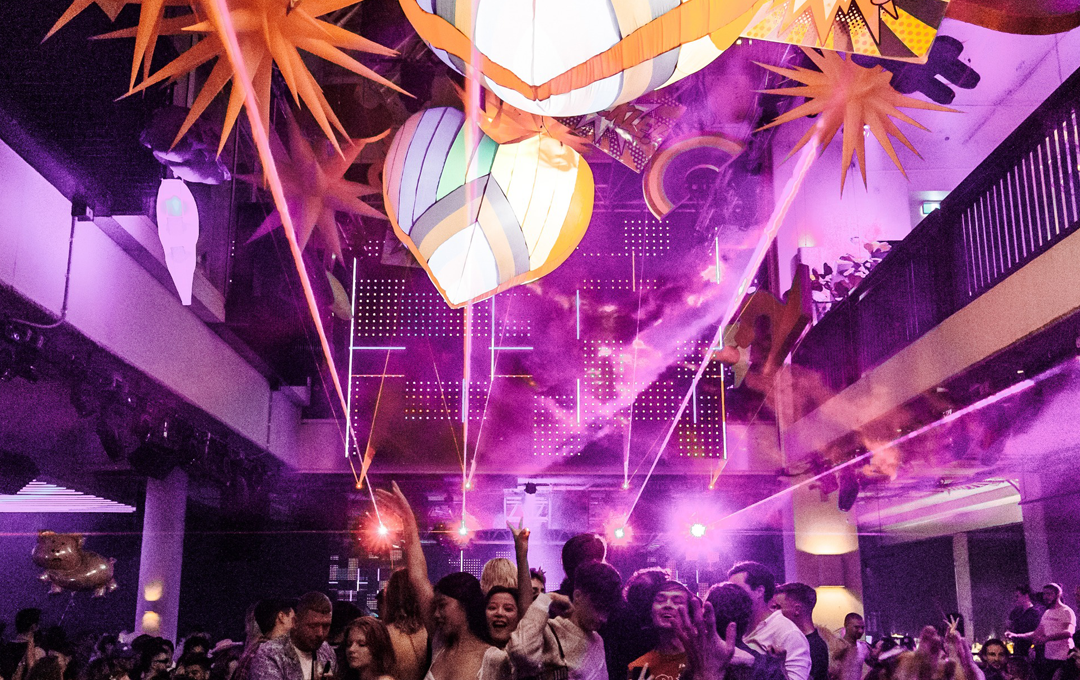 A heaving dance-floor with overhead lights at one of the best nightclubs in Melbourne