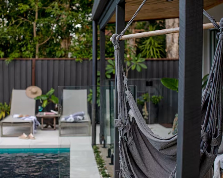 A view of the pool and hammock at Pool Oasis one of the best Noosa Airbnbs