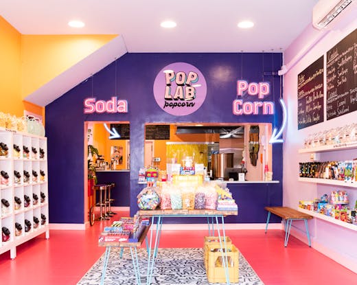 A large colourful store with candy and popcorn. 