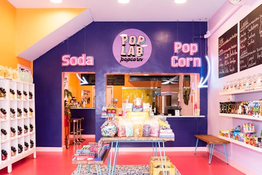 A large colourful store with candy and popcorn.