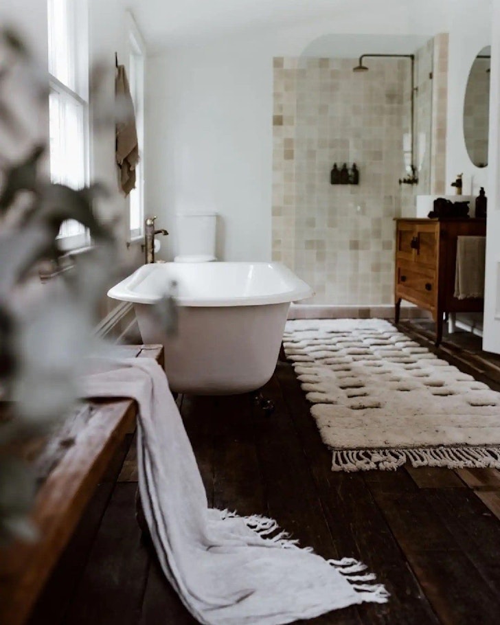 The bathroom with bath and shower at The Postman's Cottage country escape