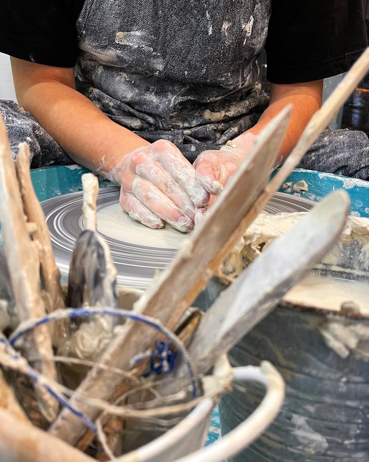 a person using a pottery wheel making ceramic at a best pottery class Melbourne