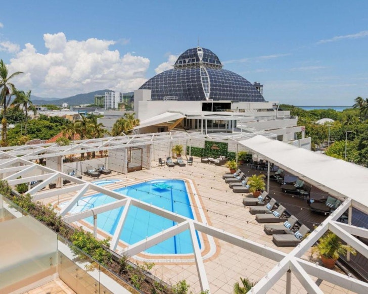 An exterior view of Pullman Reef Hotel Casino and pool, one of the best hotels in Cairns